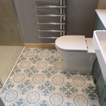 image of bathrrom tiles & toilet by Sutton & Vining