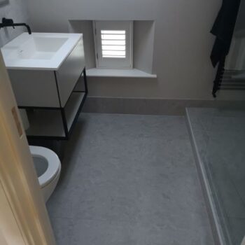image of small bathroom floor & sink by Sutton & Vining