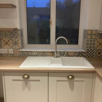 close up image of white kitchen units and sink