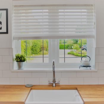 image of blind in kitchen with sink set into wood