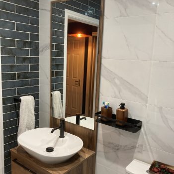 modern bathroom with grey tiles and wooden vanity