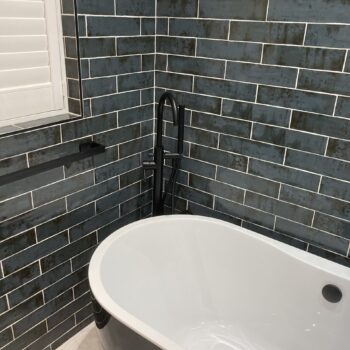 close up of bathroom with grey tiles