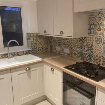 white kitchen units with modern tiling